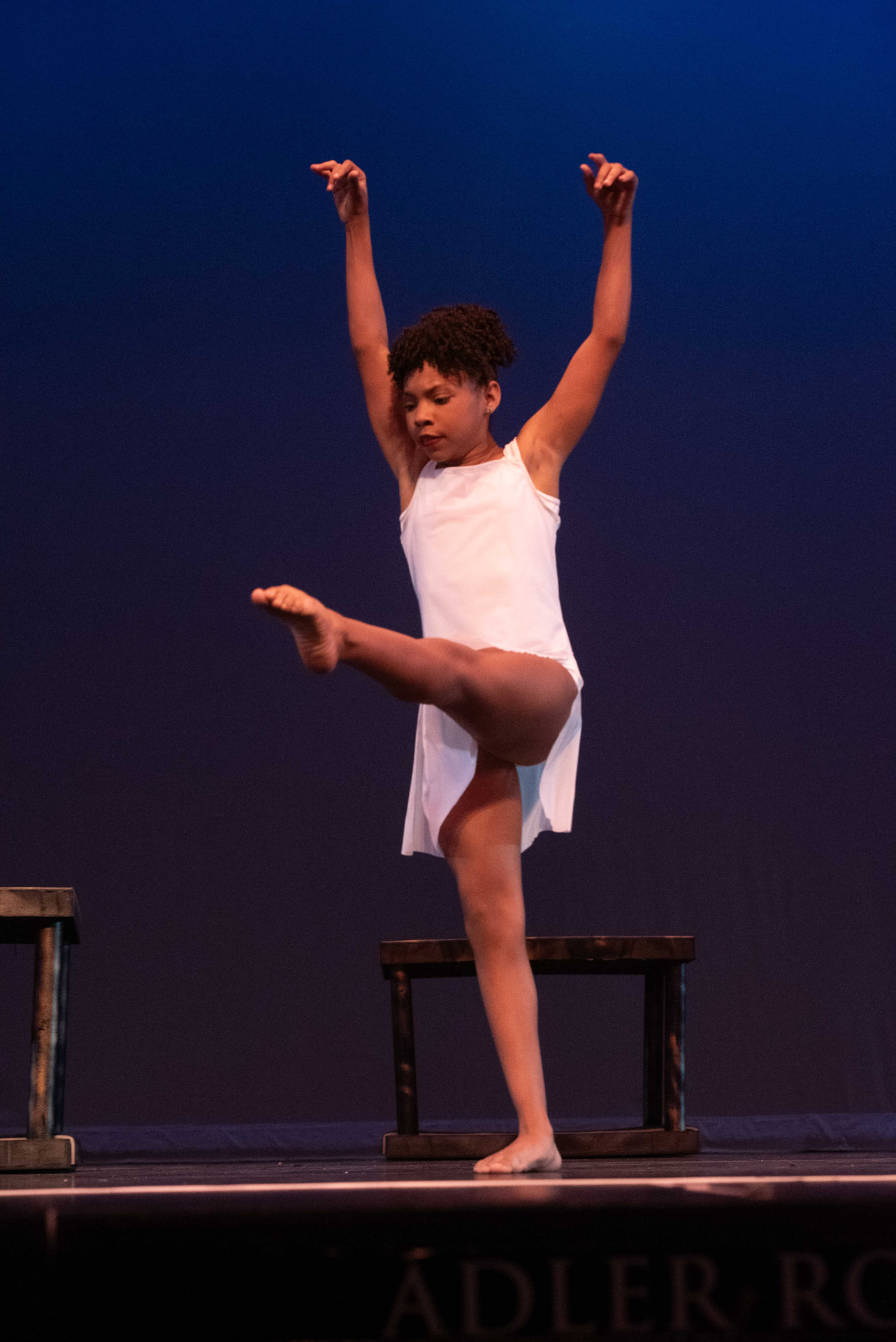 A Virtues In Motion student performing in a white lyrical costume at the 2026 VIM recital